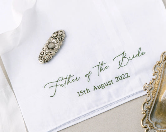 Embroidered handkerchief with 'Father of the Bride' text and date on a white background