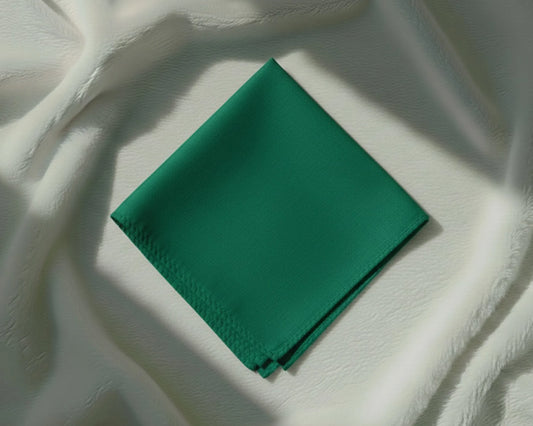 Green fabric square on a textured white surface