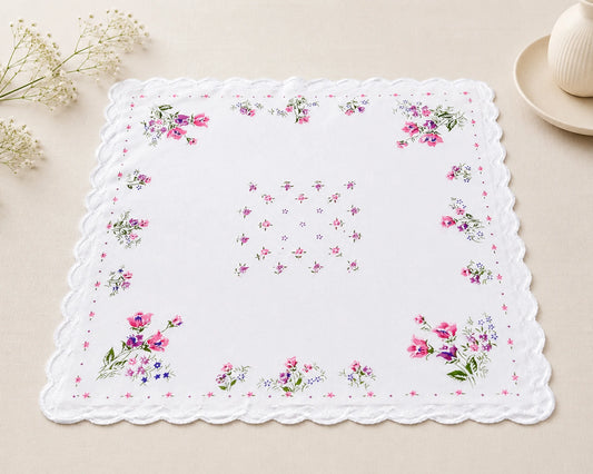 Floral-patterned handkerchief on a beige surface with decorative elements.
