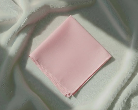 Pink fabric on a textured light green surface