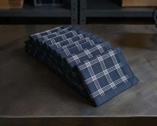 Set of blue plaid checked hanky on a wooden surface