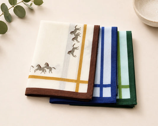 Set of folded hankie with animal designs on a light surface