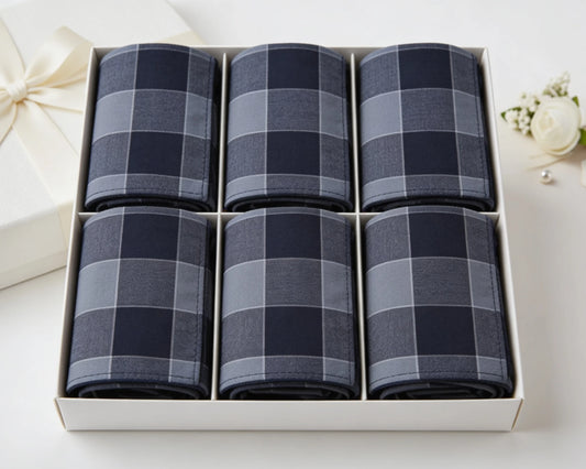 Set of six blue checkered handkerchiefs in a white box on a white background.