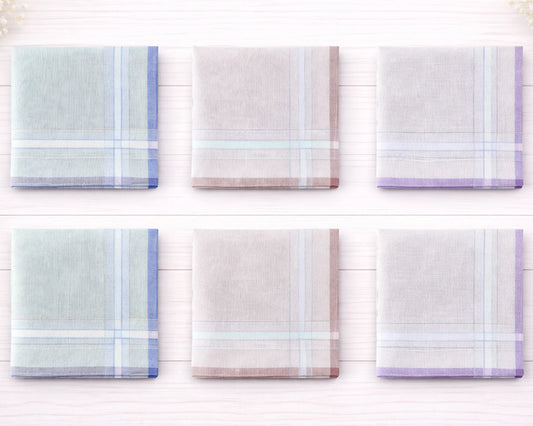 Set of six plaid handkerchiefs in pastel colors on a white wooden background