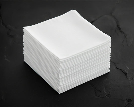 Stack of white hanky on a dark surface