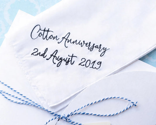 White handkerchief with 'Cotton Anniversary 2nd August 2019' text on a light blue background
