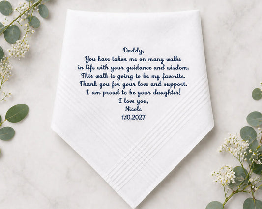 White handkerchief with personalized message on a light background with greenery