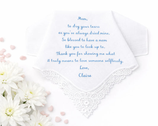 White handkerchief with embroidered text and flowers on a white background