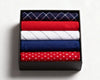 Navy checkered and red polka dot hanky on a white marble surface