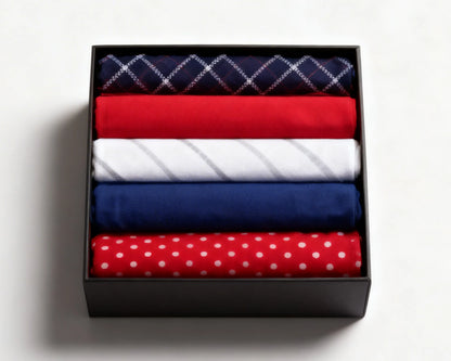 Navy checkered and red polka dot hanky on a white marble surface