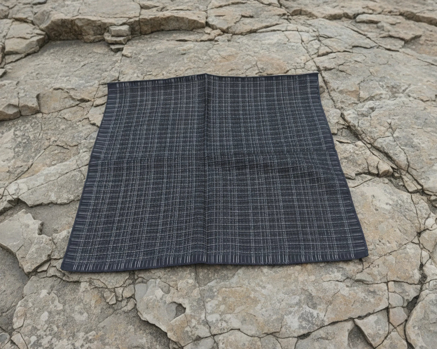 Black checkered hanky on a stone surface