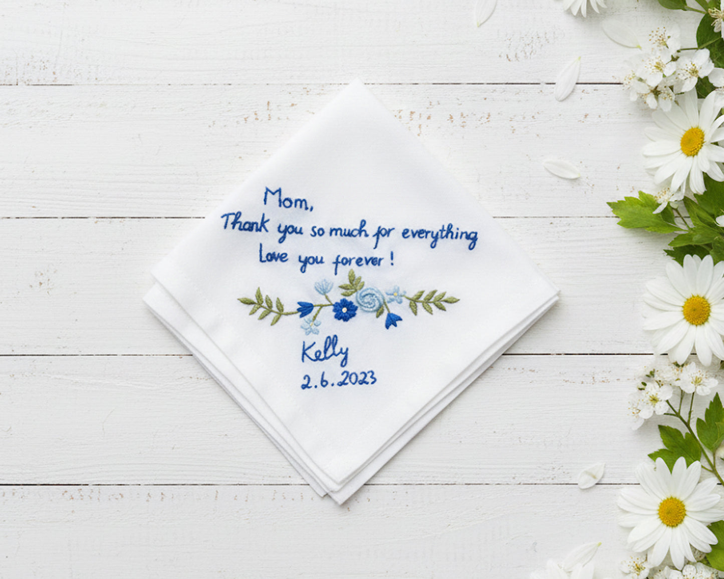 White cotton handkerchief featuring blue floral vine embroidery and a personalized thank you message for mom