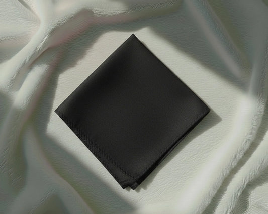 Black square napkin on a textured white surface