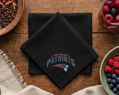 Black New England Patriots hankie on a wooden table with fruit bowls.