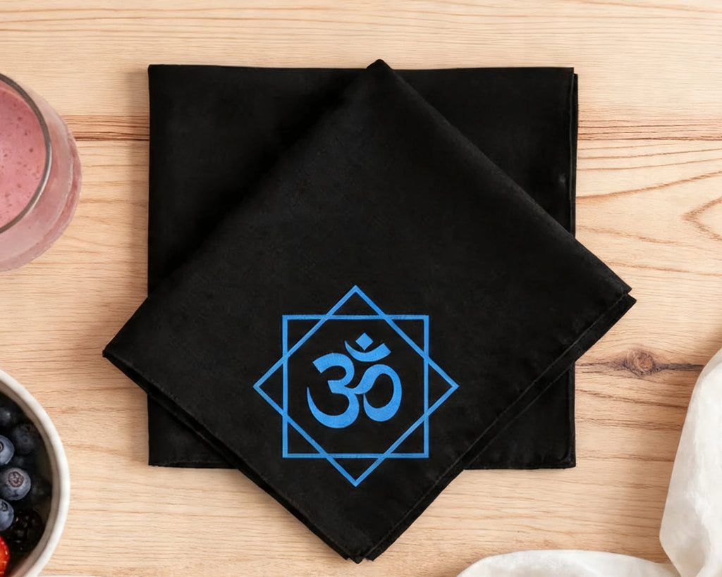 Black hanky  with blue Om symbol on a wooden table