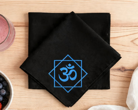 Black hanky  with blue Om symbol on a wooden table