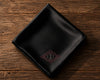 Black satin hanky with a monogram on a wooden surface