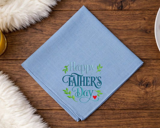 Blue hanky with 'Happy Father's Day' text on a wooden table