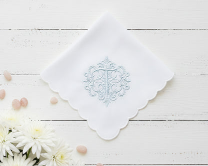 White cotton hanky for women featuring a blue embroidered letter W with vine accents and wide lace borders