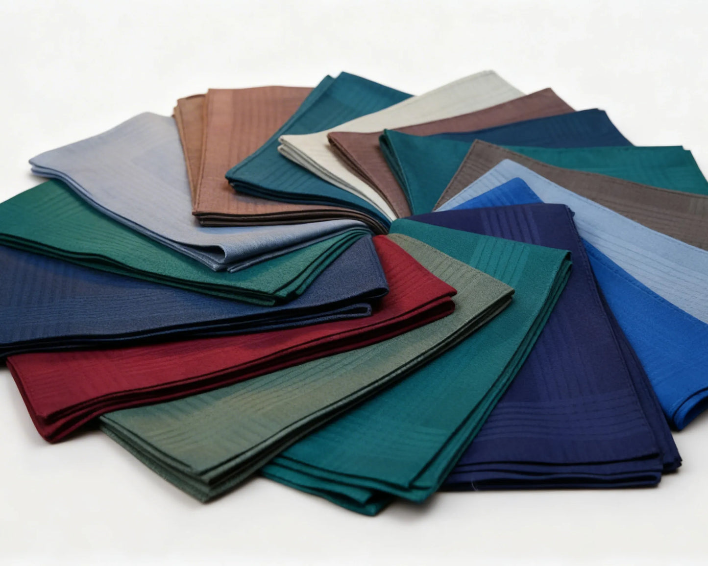 Collection of folded hanky in various colors on a white background