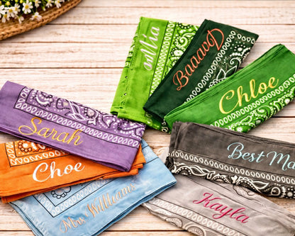 Collection of personalized bandanas with names on a wooden surface
