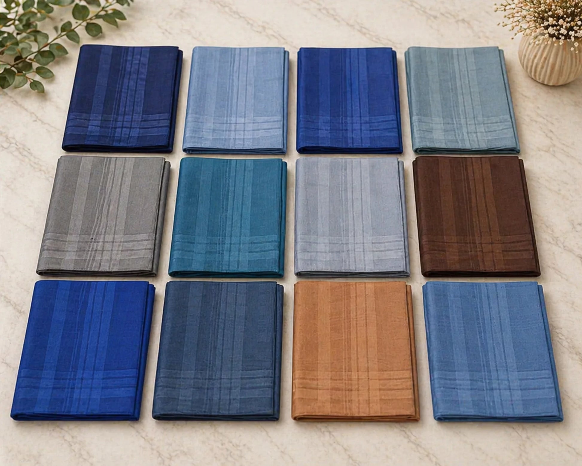 Collection of various blue and brown fabric hanky on a light surface.