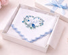 Decorative card with floral design and initials 'S&P' in a white box with a blue ribbon.