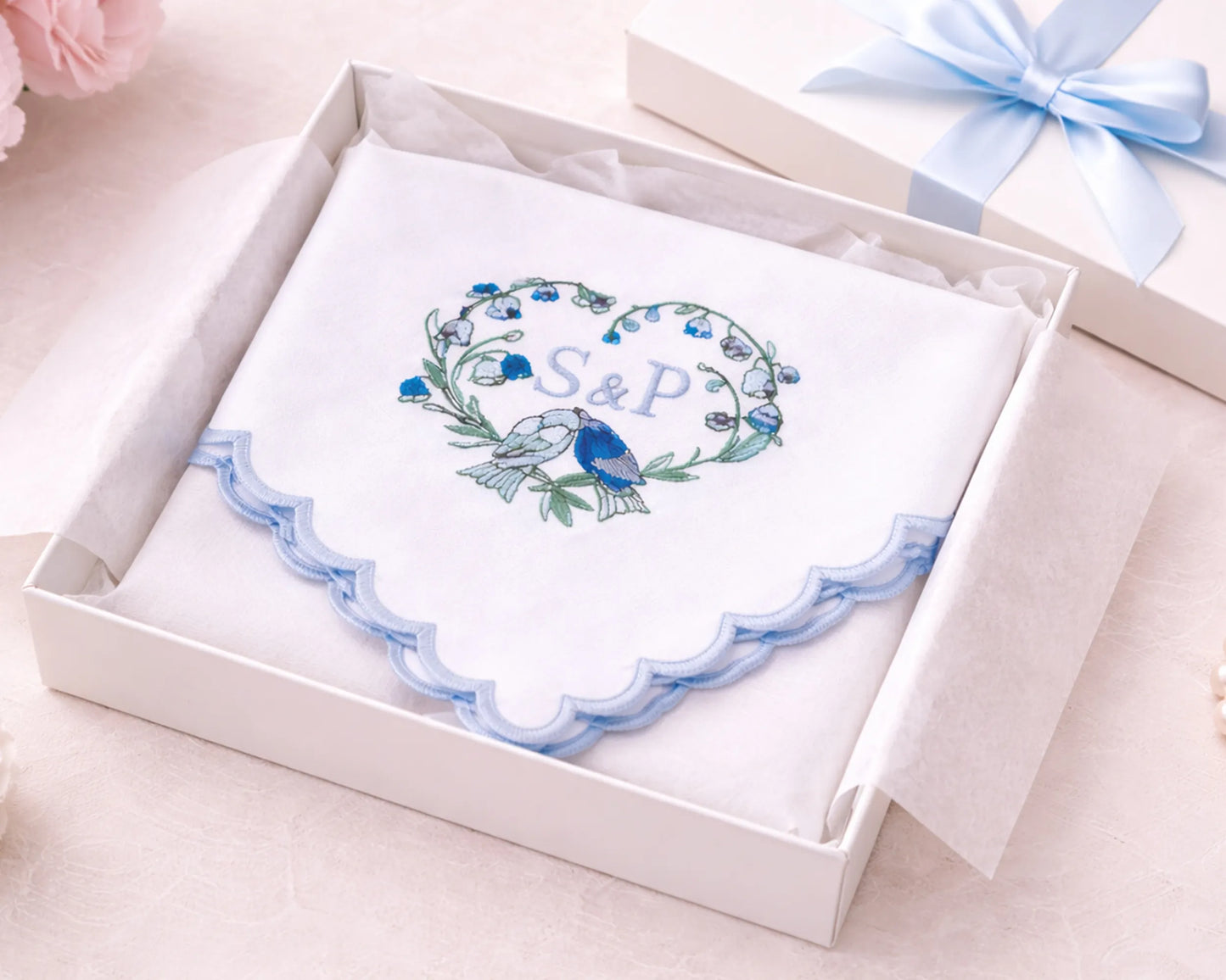 Decorative card with floral design and initials 'S&P' in a white box with a blue ribbon.