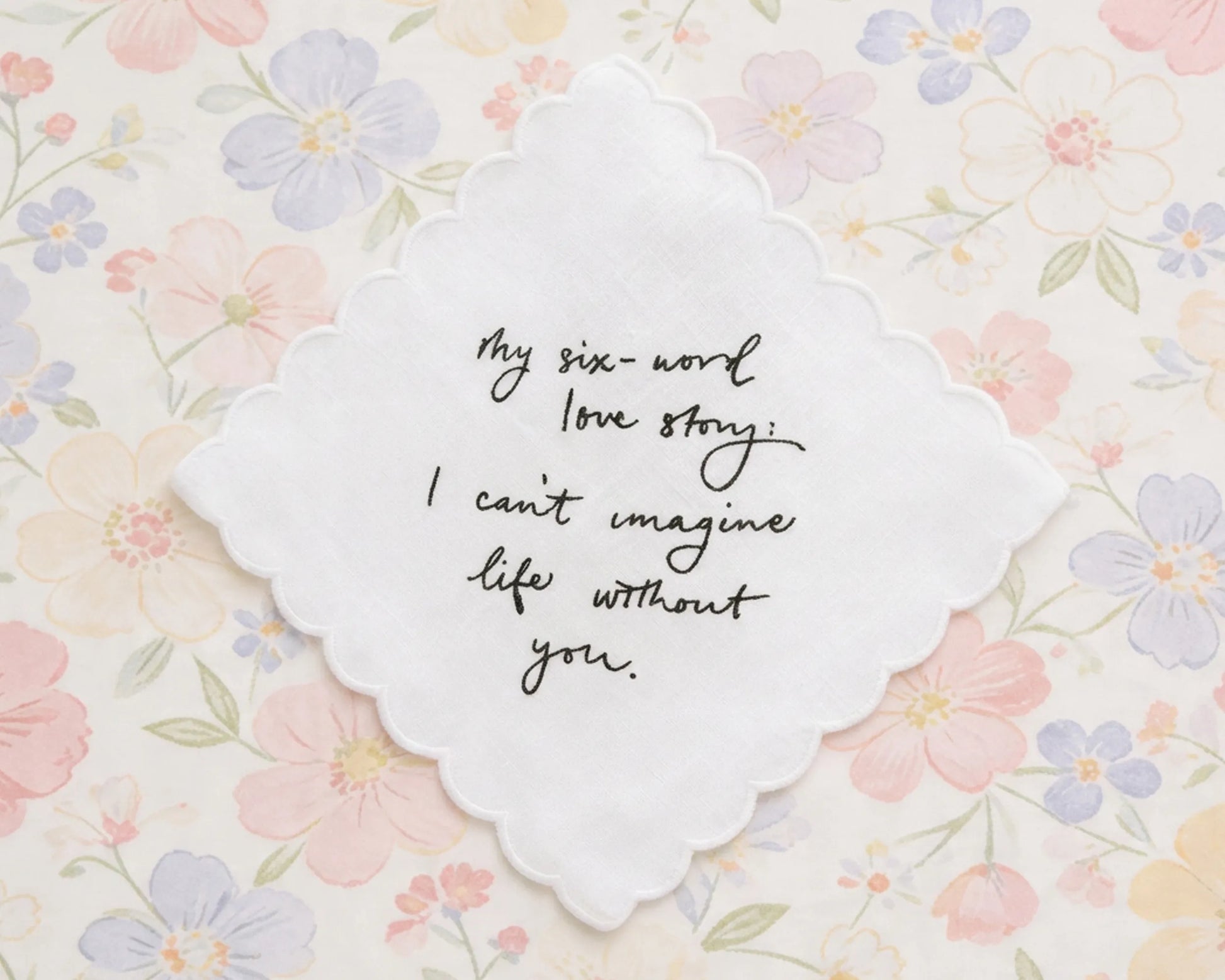 Decorative card with six-word love story on a floral background