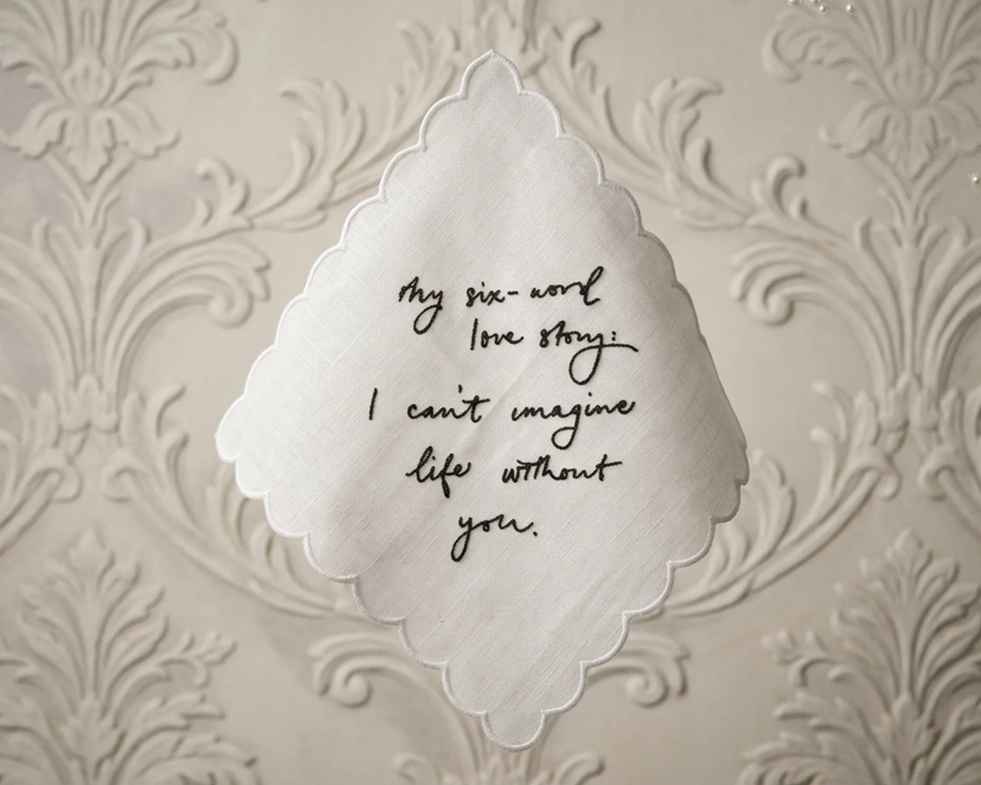 Decorative paper with a six-word love story on an ornate background
