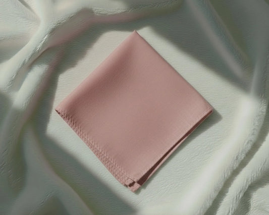 Pink fabric on a textured white surface