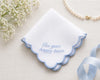 Embroidered handkerchief with 'For your happy tears' text on a light background with flowers and ribbon.