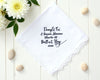 White cotton wedding handkerchief with navy blue embroidery and a wide scalloped lace border framed by white spring flowers