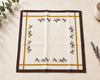 Fabric square with horse pattern on a beige surface