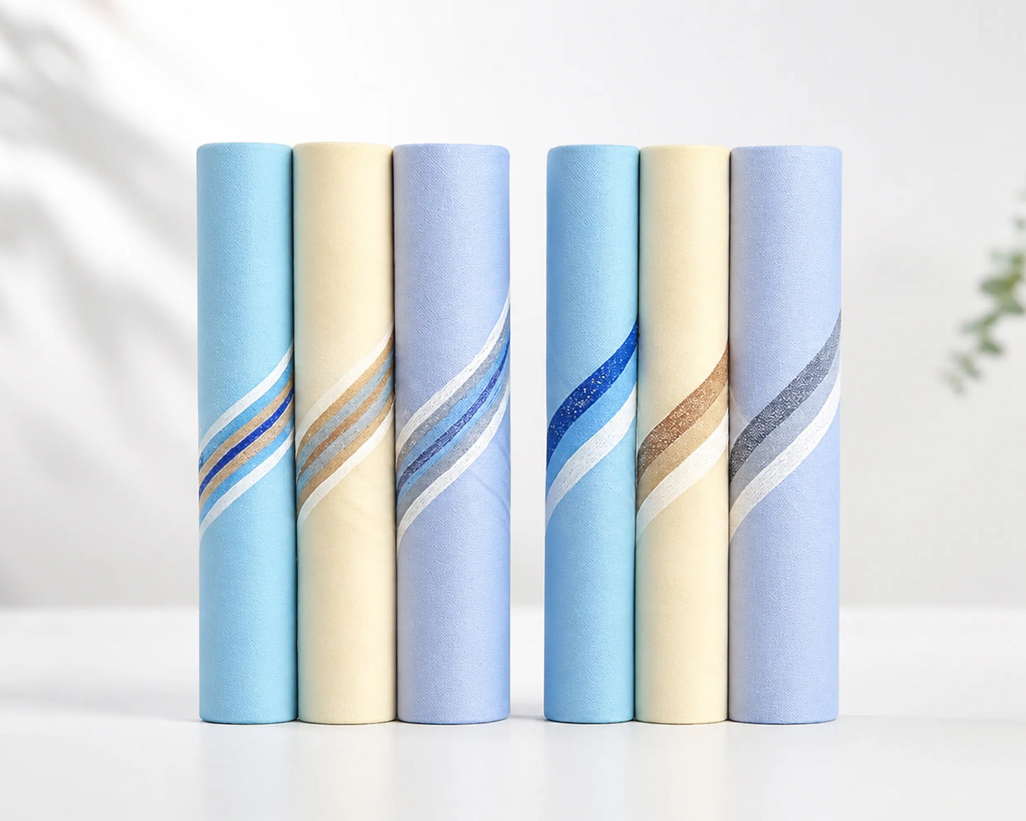 Five hanky products with blue and beige patterns on a white background