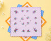 Floral-patterned handkerchief with colorful border on a yellow background