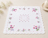 Floral-patterned handkerchief on a beige surface with decorative elements.