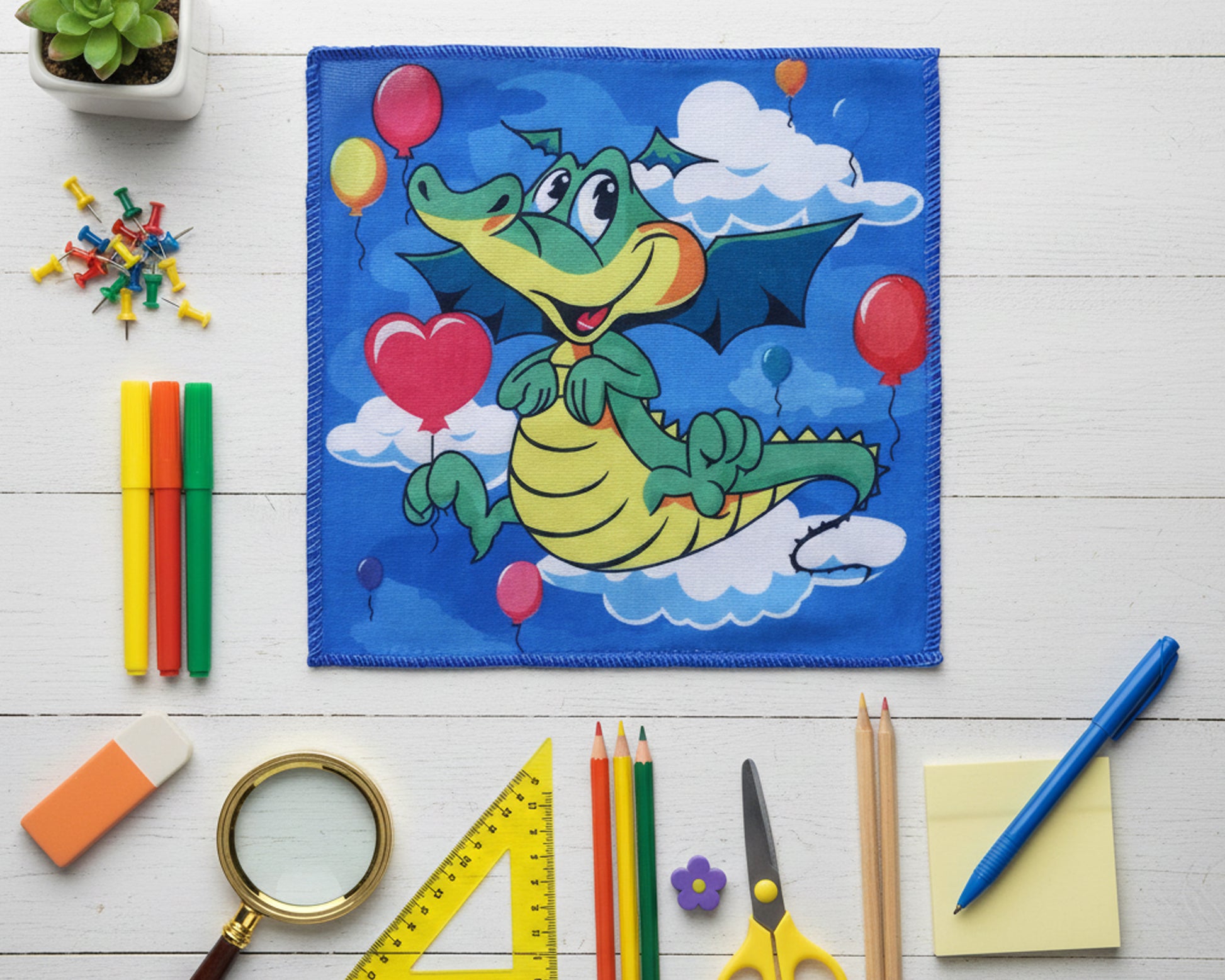 Vibrant blue kids handkerchief with a friendly green dragon and balloons made in the usa