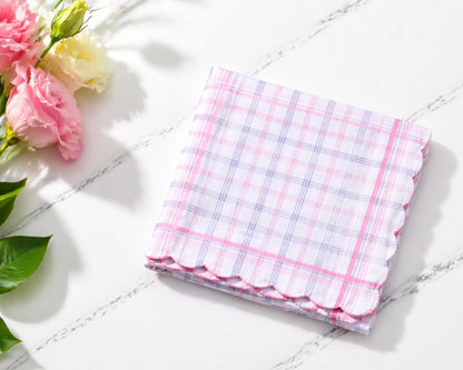 Folded checkered handkerchief on a marble surface with flowers