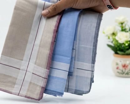 Folded handkerchiefs in various patterns held by a hand on a light background