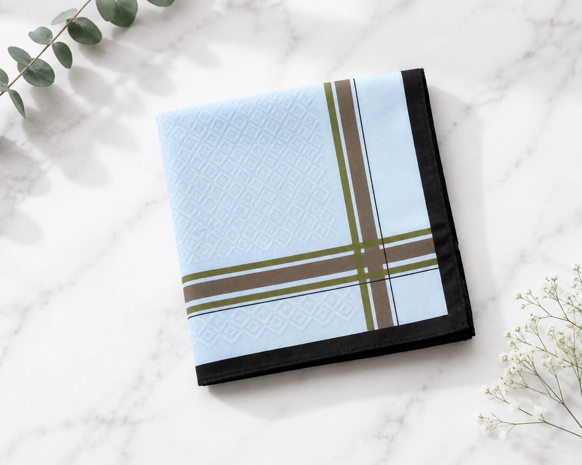 Folded  hanky with plaid pattern on a marble surface