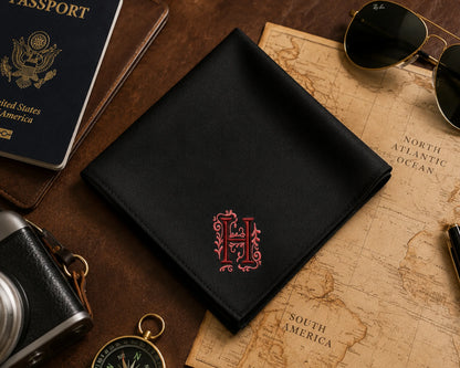 Folded white handkerchief with 'New Man' embroidery on a wooden surface.