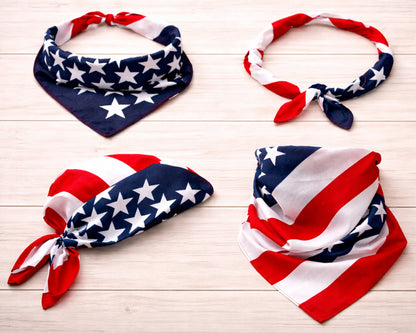 Four American flag-themed bandanas on a light wooden surface