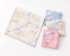 Four floral-patterned handkerchiefs in pastel colors on a white background