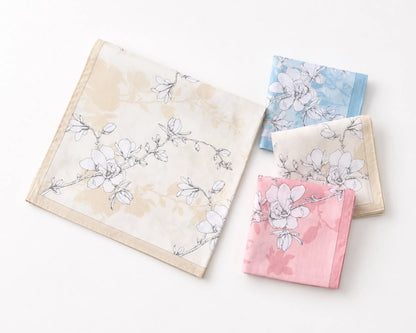 Four floral-patterned handkerchiefs in pastel colors on a white background