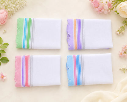 Four folded hanky with colorful stripes on a light background with flowers.