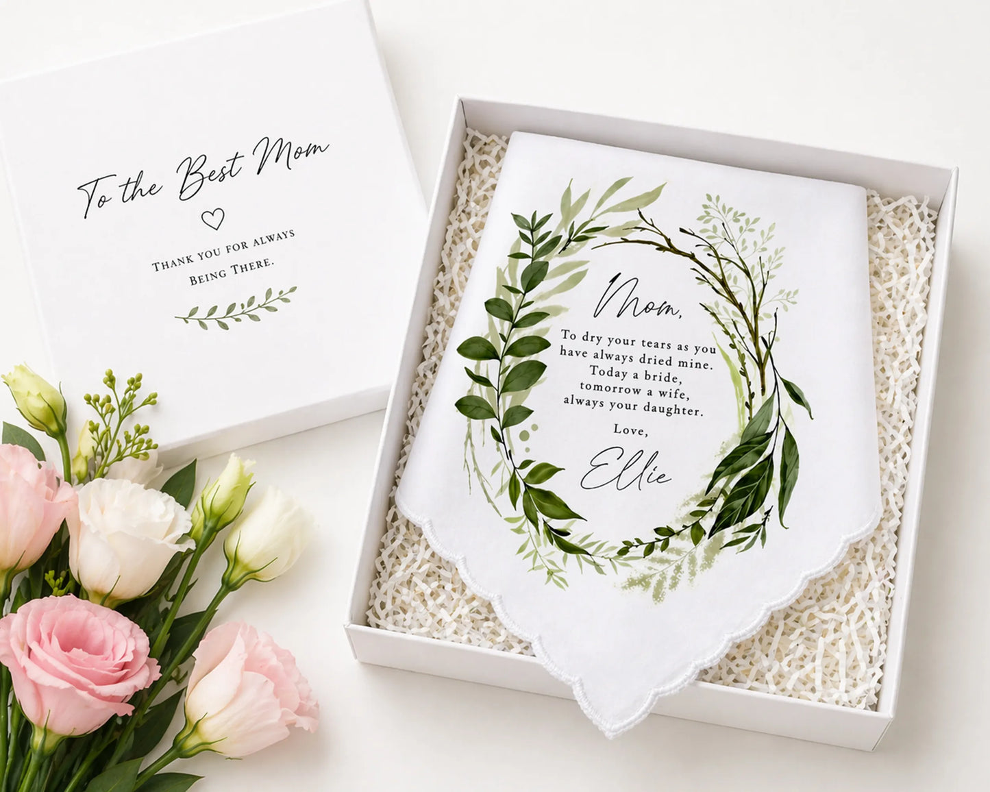Gift box with a personalized towel and flowers on a white background