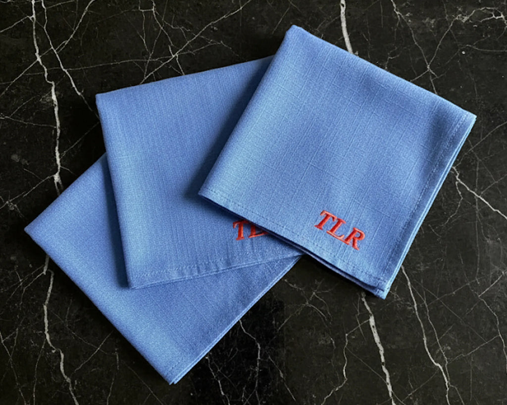 White cotton wedding hanky with gold embroidered poetry for a daughter and scalloped lace on white wood