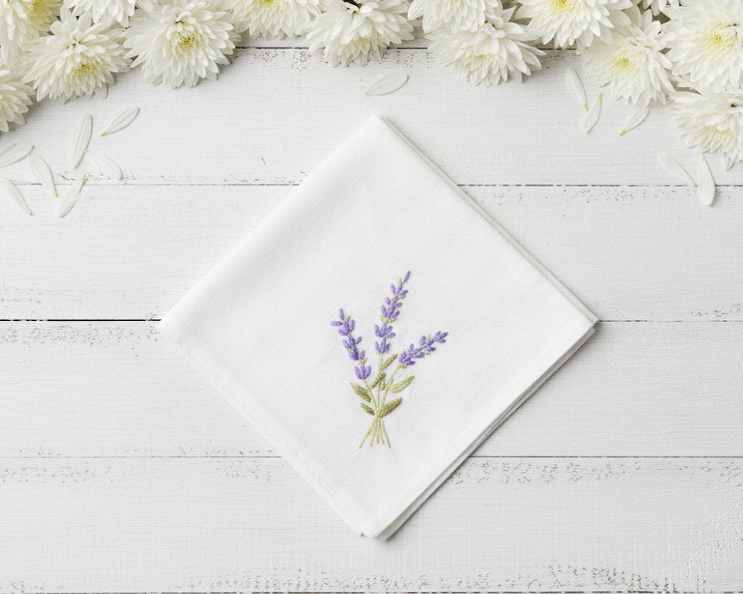 Pure white cotton handkerchief featuring centered violet lavender embroidery with green foliage on a light wood backdrop