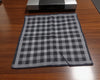 Gray and black checkered fabric on a wooden surface